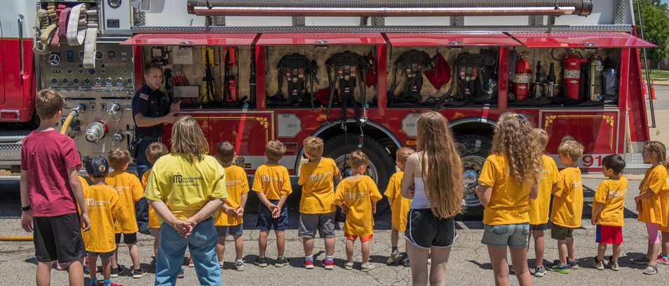 Safety Town participants and volunteers learning about fire trucks on fire safety day.