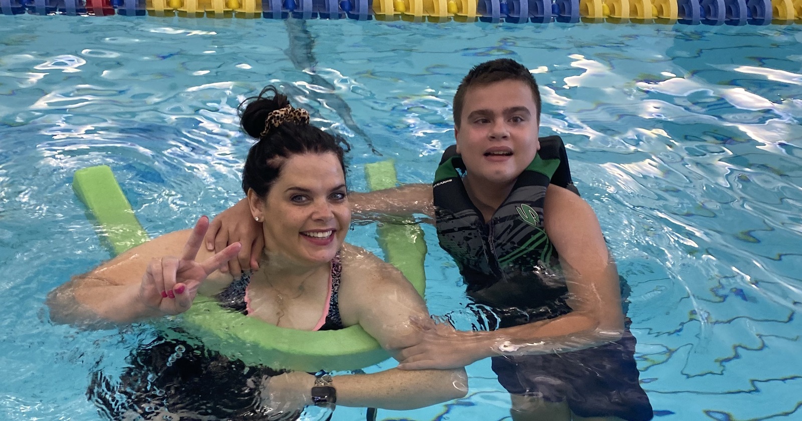 Student and staff in the pool