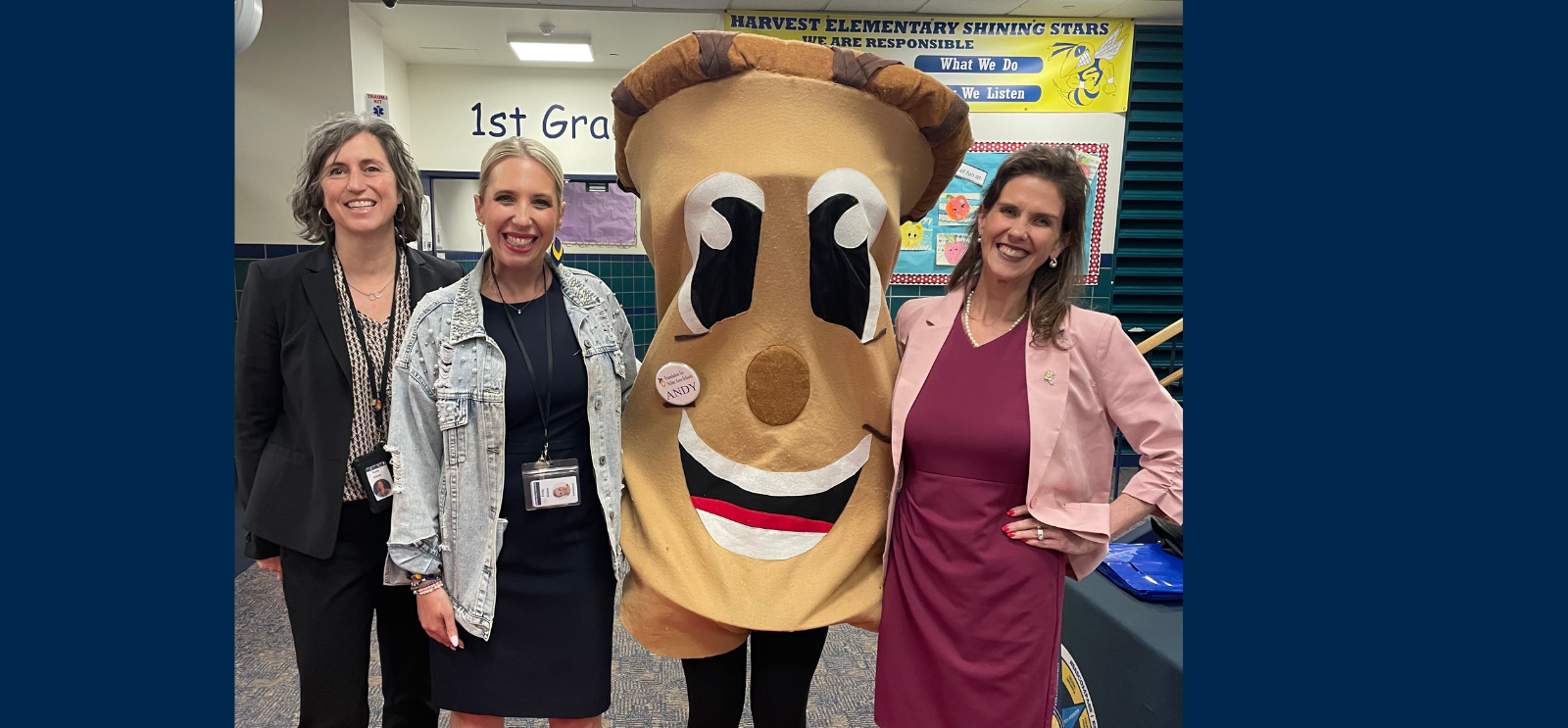Staff standing with Andy the Acorn at Open House
