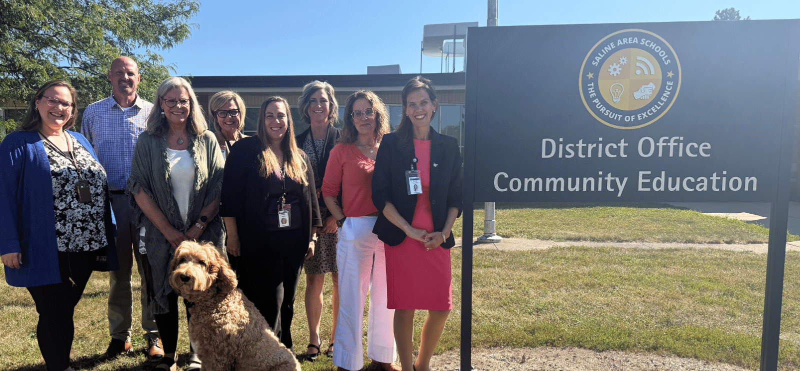 Core administrative team members pose for a photo outside of the District office at Liberty school