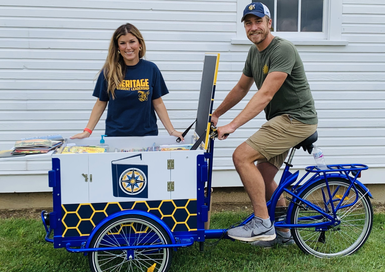 Principal DeGrand and Assistant Principal Cochran on the book bike